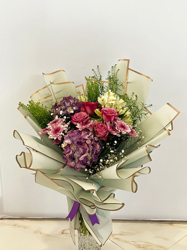 Pearl Petal Purple Bouquet with hydrangeas, mums, and roses wrapped in decorative paper – Petal Frost flower shop