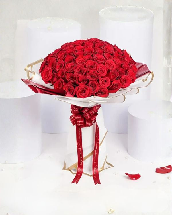 Bouquet of red roses with a red ribbon on a white background