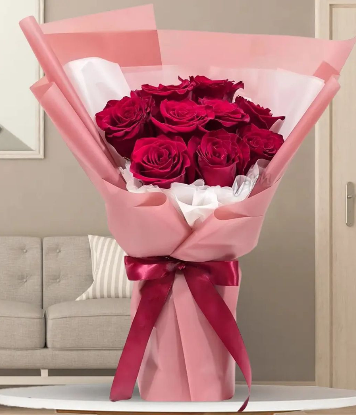 Sweet Scarlet Symphony a bouquet of vibrant red roses wrapped in pink paper with a decorative bow– Petal Frost flower shop