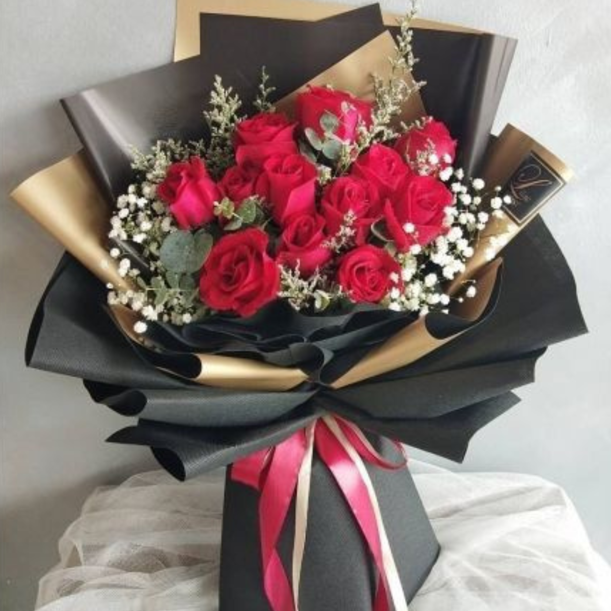 Valentine’s Embrace bouquet – 12 red roses  with baby roses and eucalyptus – Petal Frost Dubai