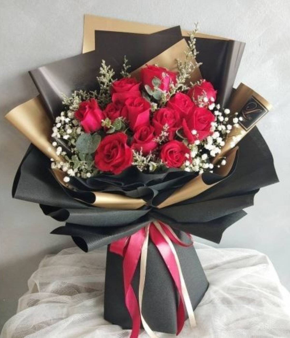 Valentine’s Embrace bouquet – 12 red roses  with baby roses and eucalyptus – Petal Frost Dubai