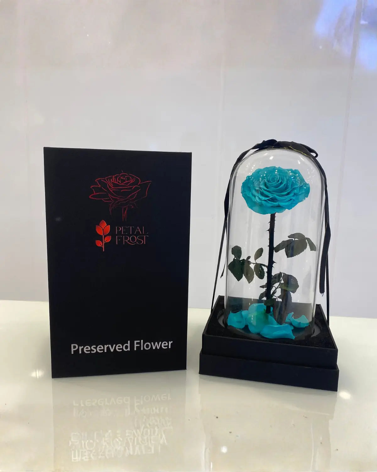 Blue preserved rose in a glass dome 'Dubai flower shop' 